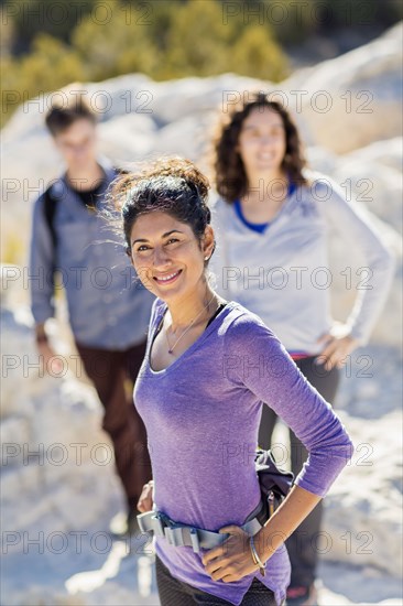 Hikers smiling on rocky hilltop