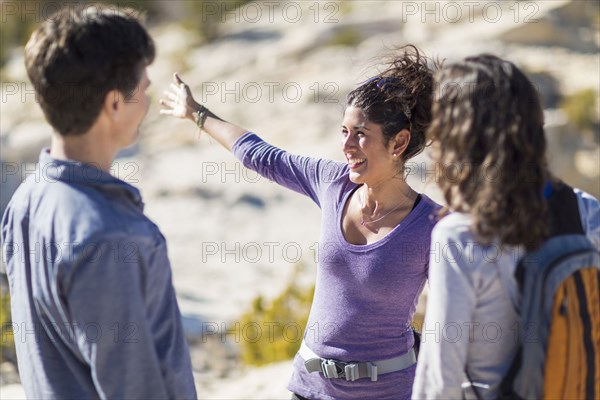 Hikers talking on rocky hilltop