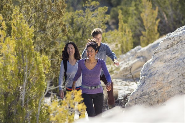 Hikers climbing rocky hillside