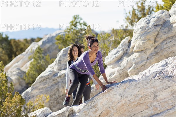 Hikers climbing rocky hillside