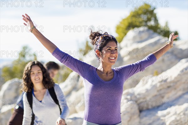 Hikers climbing rocky hillside