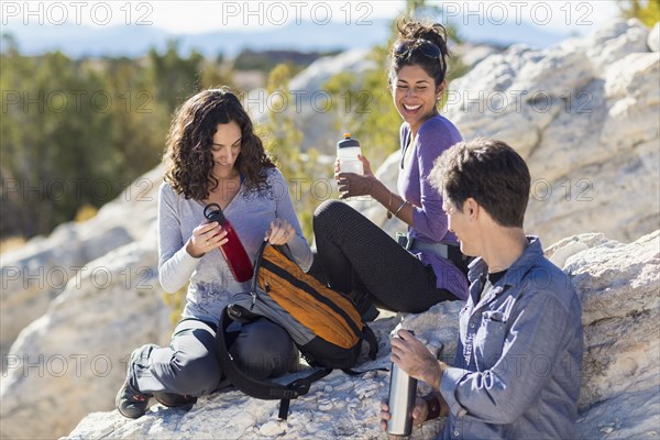 Hikers resting on rocky hillside