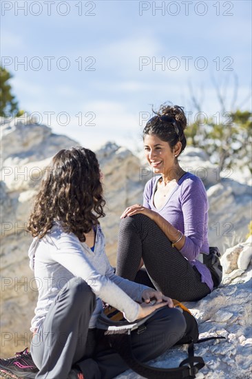 Hikers talking on rocky hilltop