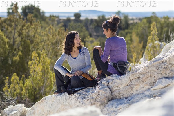 Hikers talking on rocky hilltop