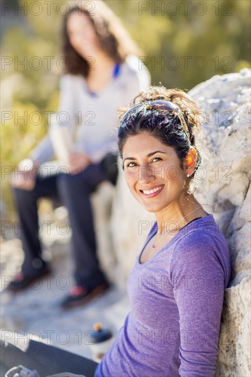 Hiker smiling on rocky hillside