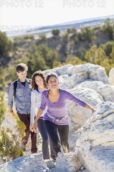 Hikers climbing rocky hillside