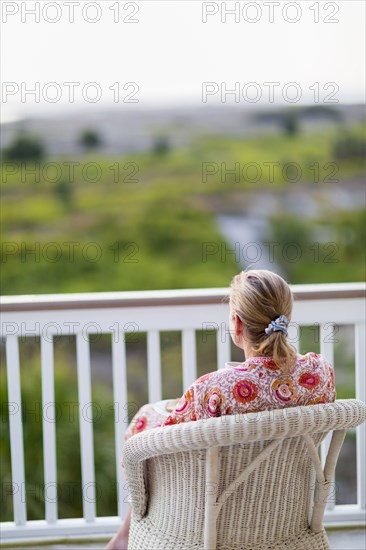 Caucasian woman admiring view from porch