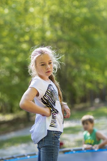 Caucasian girl standing on trampoline