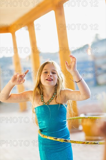 Caucasian girl playing with plastic hoop