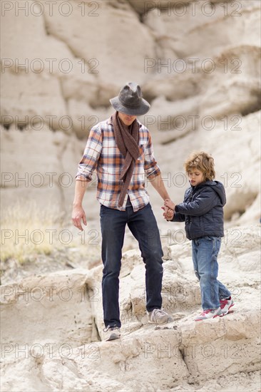 Father and son exploring desert rock formations