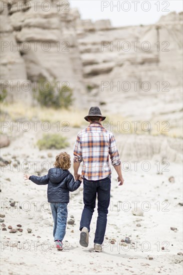 Father and son exploring desert rock formations