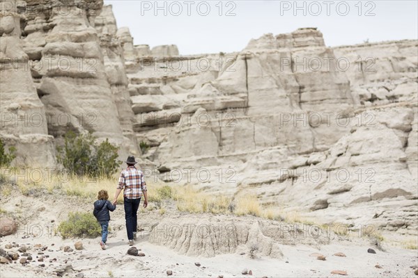 Father and son exploring desert rock formations