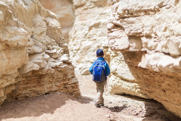 Boy exploring desert rock formations