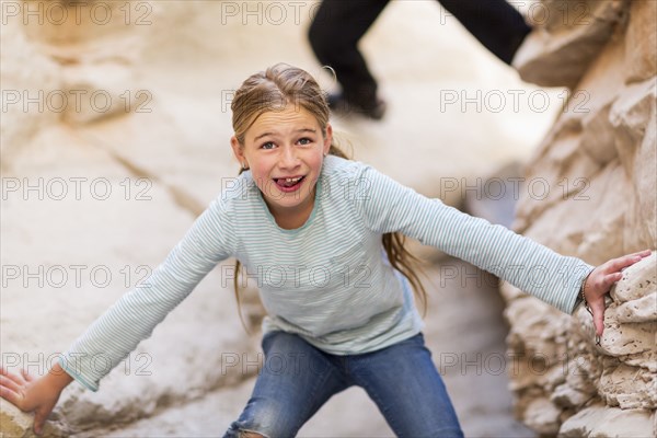 Caucasian girl exploring desert rock formations