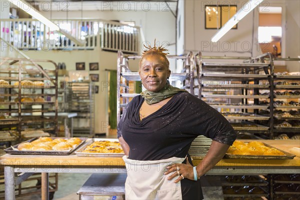 Black baker standing in bakery kitchen