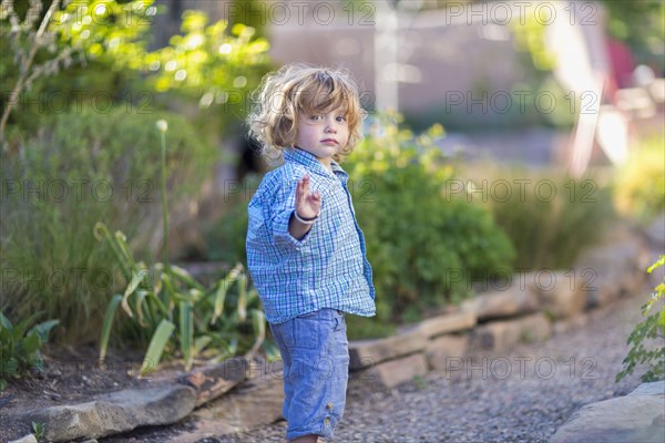 Caucasian baby boy playing in garden