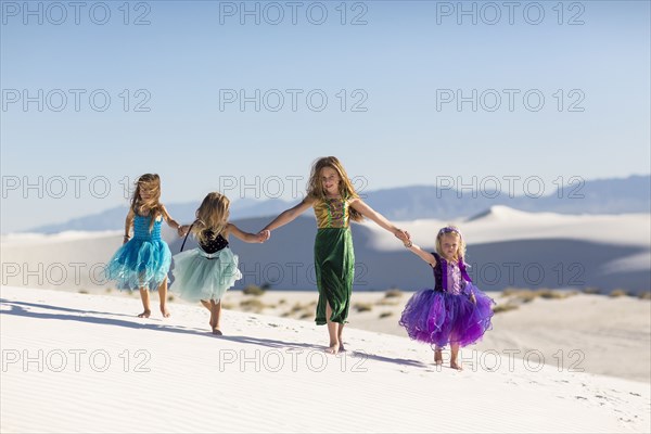 Girls walking on desert sand dunes