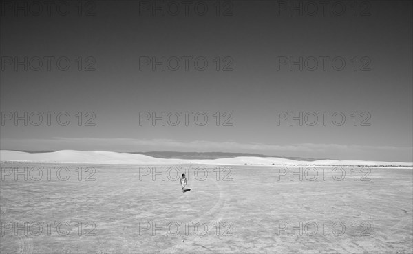 Caucasian girl lost in desert landscape