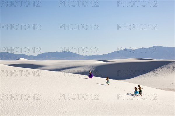 Girls walking on desert sand dunes