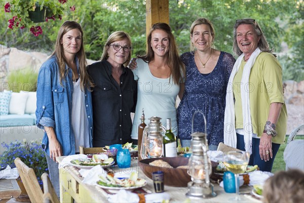 Caucasian women smiling at table outdoors