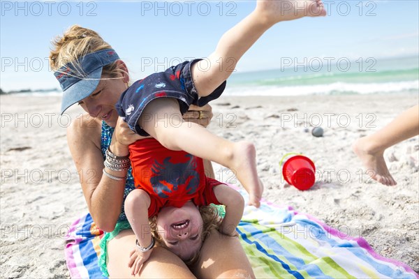 Caucasian family playing on beach