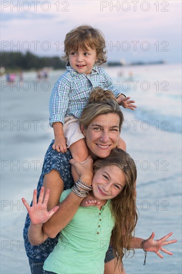 Caucasian family playing on beach