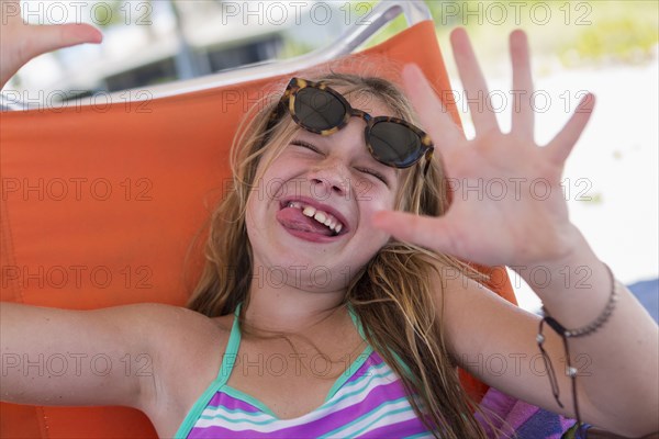 Caucasian girl making a face on beach