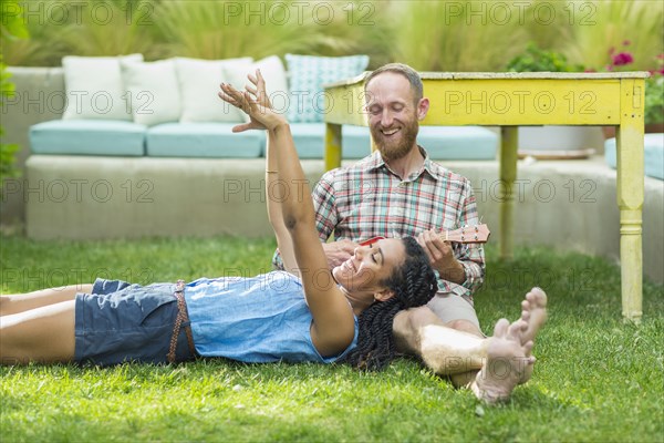 Couple relaxing in backyard