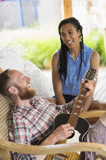 Couple playing music in backyard