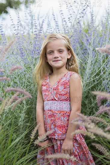 Caucasian girl smiling in tall grass