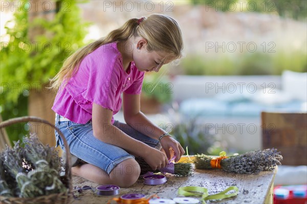 Caucasian girl wrapping dried flower bundle