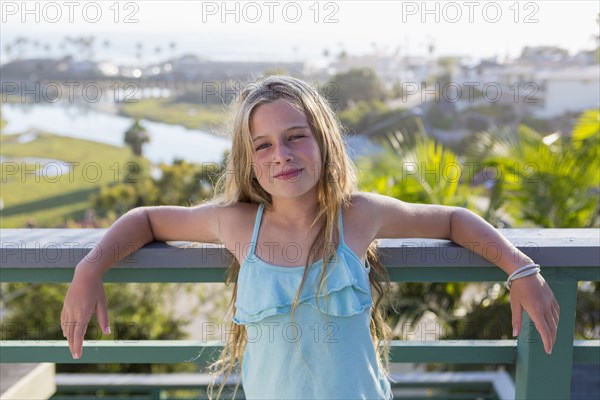 Caucasian girl standing on balcony