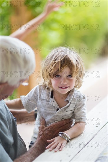 Caucasian grandfather and grandson sitting at table