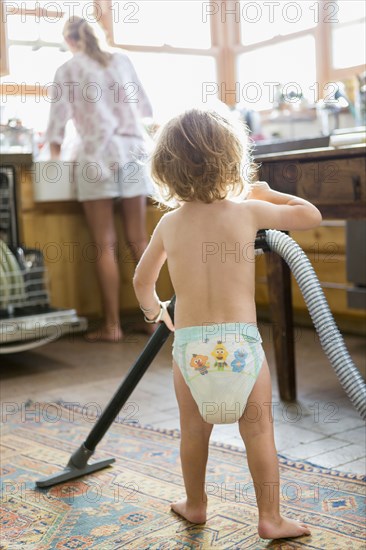 Caucasian boy helping mother do chores