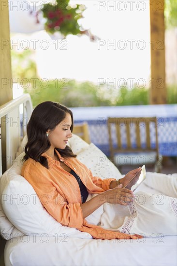 Mixed race woman using digital tablet