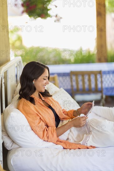 Mixed race woman using digital tablet