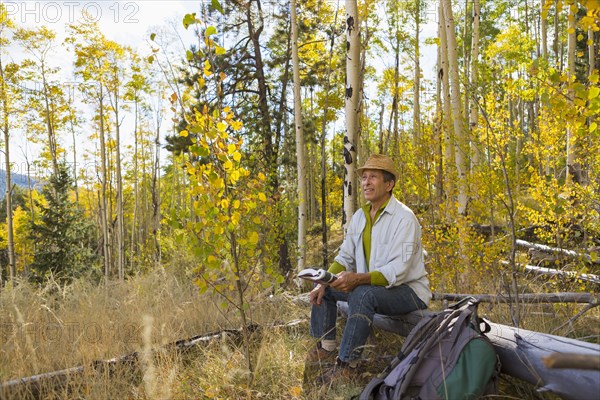 Man sitting in autumn forest