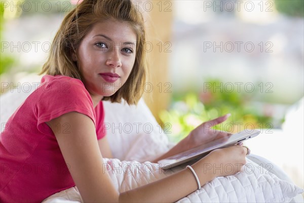 Mixed race woman using digital tablet