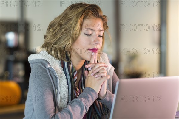 Mixed race teenage girl using laptop
