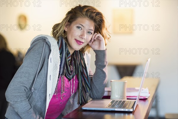 Mixed race teenage girl using laptop