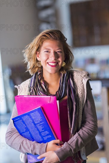 Mixed race student carrying books