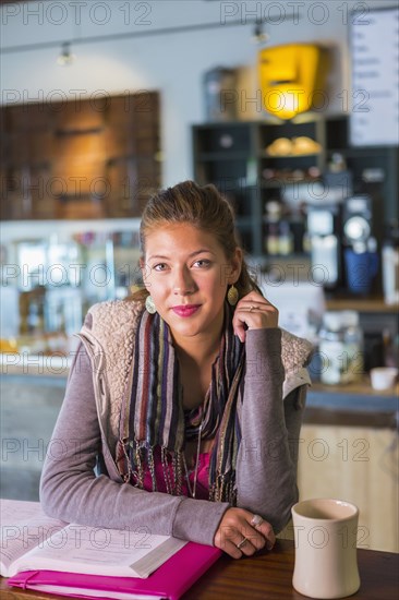 Mixed race student studying in cafe