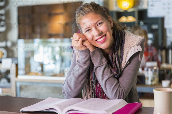 Mixed race student studying in cafe