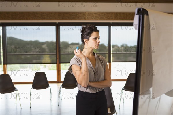 Mixed race businesswoman working in meeting room