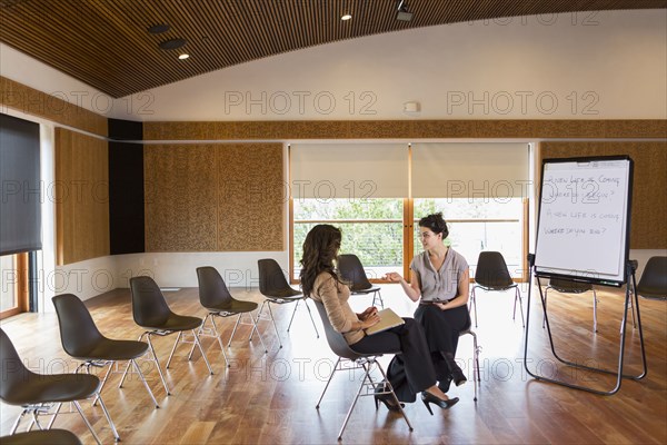 Businesswomen talking in meeting room