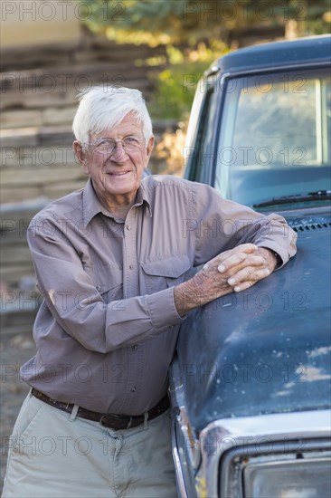 Older Caucasian man standing at truck