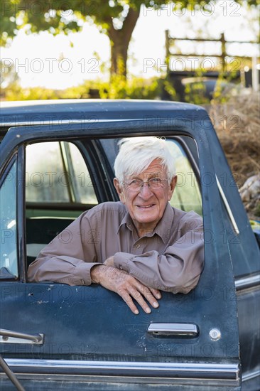 Older Caucasian man sitting in truck