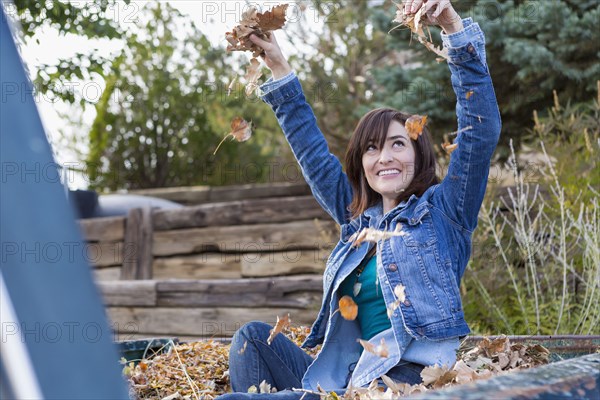 Hispanic woman playing in truck bed