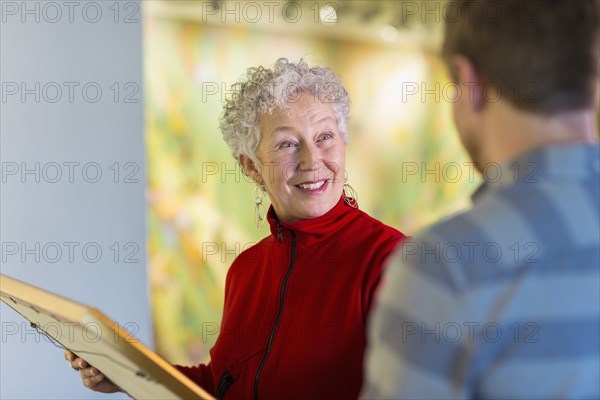 People talking in art gallery
