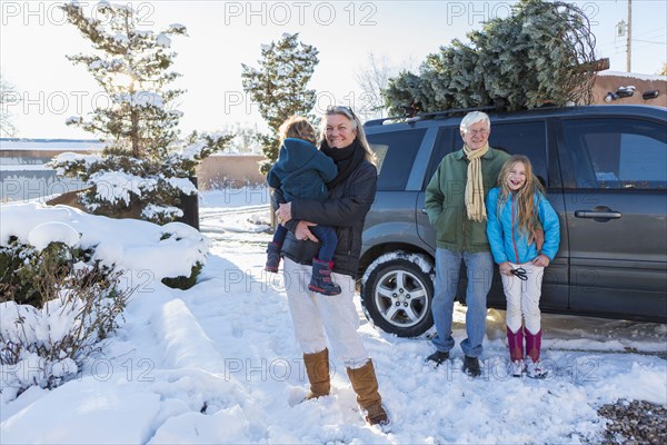 Caucasian family smiling in snow